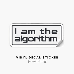 May include: A rectangular vinyl decal sticker with a white background and a black border. The text "I am the algorithm" is printed in a bold, dark gray sans-serif font in the center. The bottom right corner of the sticker is slightly peeled up.