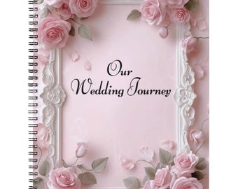 May include: A pink spiral-bound journal with the words "Our Wedding Journey" in script. The cover is decorated with a white frame and pink roses. The design includes rose petals and leaves, creating a romantic and elegant feel.