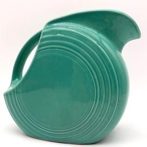 May include: A rustic wooden sign with the text "Welcome to our home" in white lettering. The sign features a distressed finish and a simple, inviting design, perfect for a front porch or entryway.