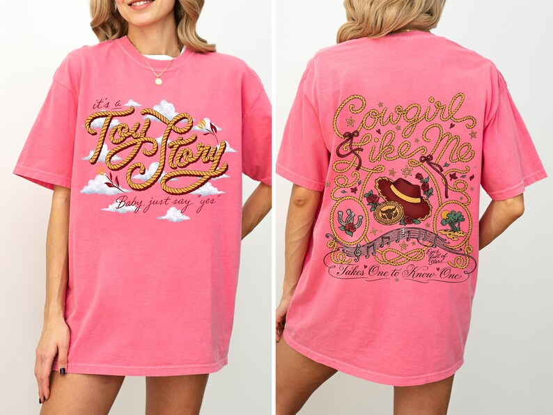 May include: A bright pink short-sleeve t-shirt featuring a front graphic with the text 'it's a Toy Story Baby, just say yes' and a back graphic with the text 'Cowgirl like Me' and 'Takes One to Know One' surrounded by rope, hat, and floral motifs.