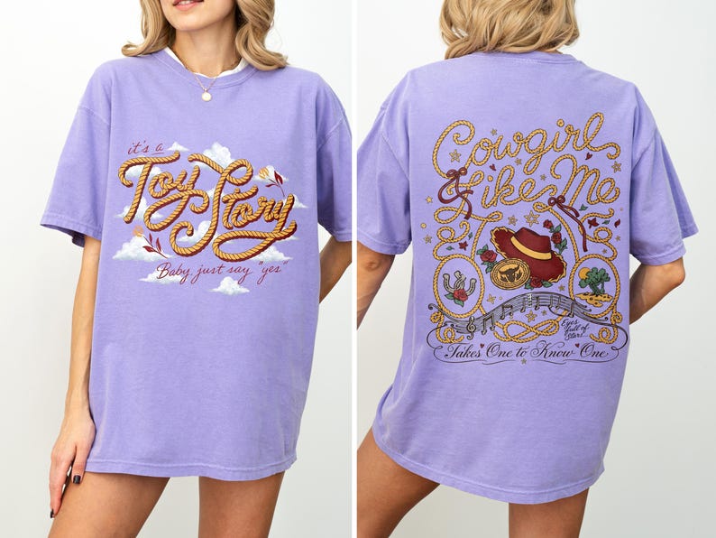May include: A light purple t-shirt featuring a front graphic with the text "it's a Toy Story" and "Baby just say yes" with clouds. The back graphic displays the text "Cowgirl like Me" and "Takes One to Know One" with a hat, rope, and stars.