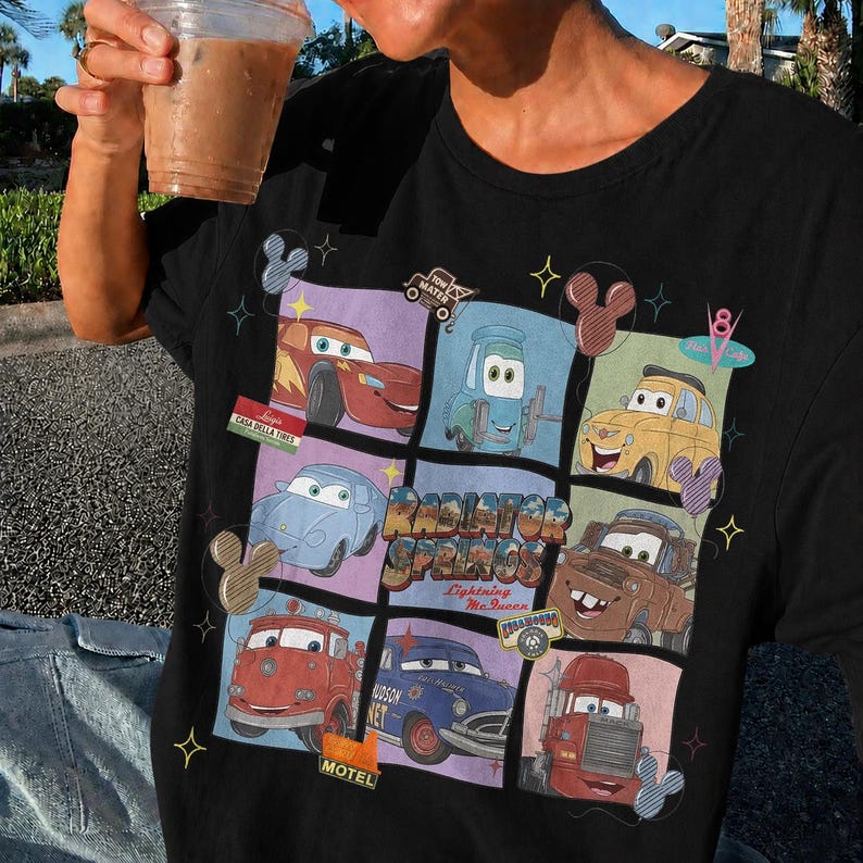 May include: A black t-shirt featuring a grid graphic of various characters from the movie Cars, including Lightning McQueen, Mater, and others. The center text reads Radiator Springs and Lightning McQueen, surrounded by small star and mouse ear icons.