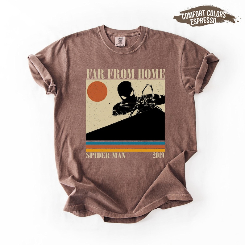 May include: Brown t-shirt with a graphic from the film "Spider-Man: Far From Home." The design features an orange sun, a Spider-Man silhouette, and the text "FAR FROM HOME" and "SPIDER-MAN 2019."