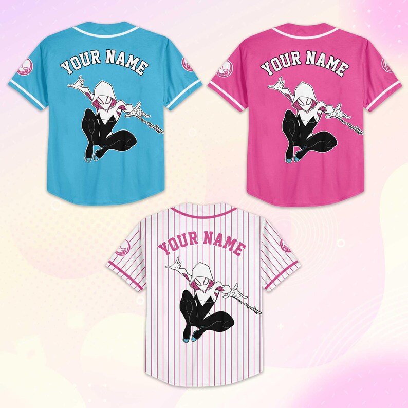 May include: Three baseball jerseys in blue, pink, and white with a superhero graphic. Each jersey has the text "YOUR NAME" on the back. The blue and pink jerseys have a solid color, while the white jersey has vertical stripes.