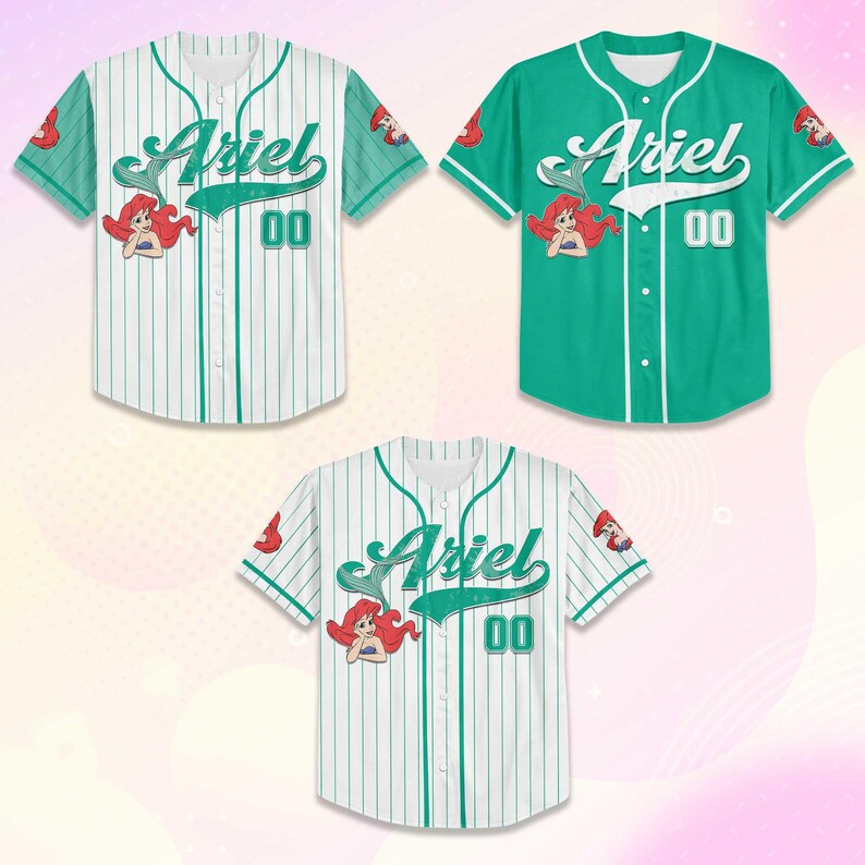 May include: Three baseball jerseys featuring the name "Ariel" in a script font. Two jerseys are white with teal pinstripes, and one is solid teal. Each jersey has the number "00" and a cartoon image of a mermaid.