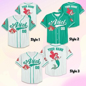 May include: Baseball jerseys in three styles, featuring the name "Ariel" and the number "00". The jerseys are white and teal, with a mermaid graphic. One jersey is solid teal. The text "YOUR NAME" is on the back of two jerseys.