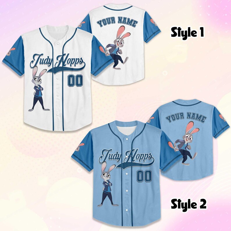 May include: Two baseball jerseys, one white and one light blue, featuring the character Judy Hopps. The white jersey has blue sleeves and trim, with "Judy Hopps" and the number "00" on the front. The light blue jersey has matching details.