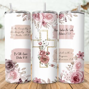 May include: Three white stainless steel tumblers with floral designs and inspirational quotes. Each tumbler has a different quote and is decorated with pink and purple roses and leaves.