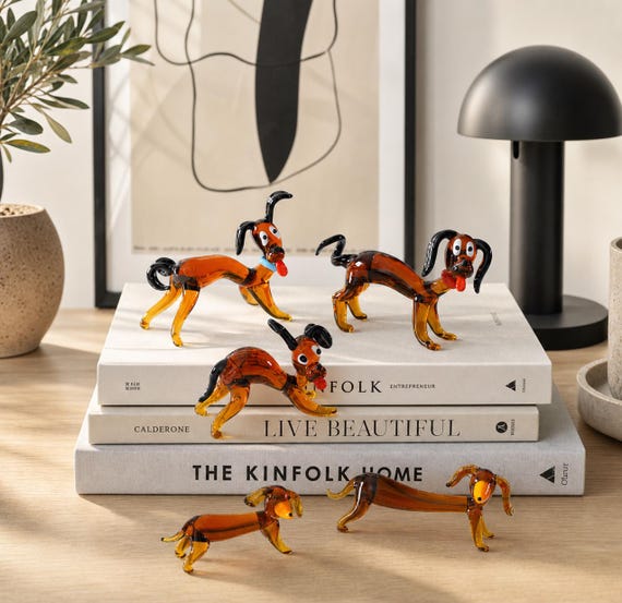 Hand-blown glass miniature dachshund — the "ugly cute" aesthetic meets genuine lampworking craft, and no two are identical.