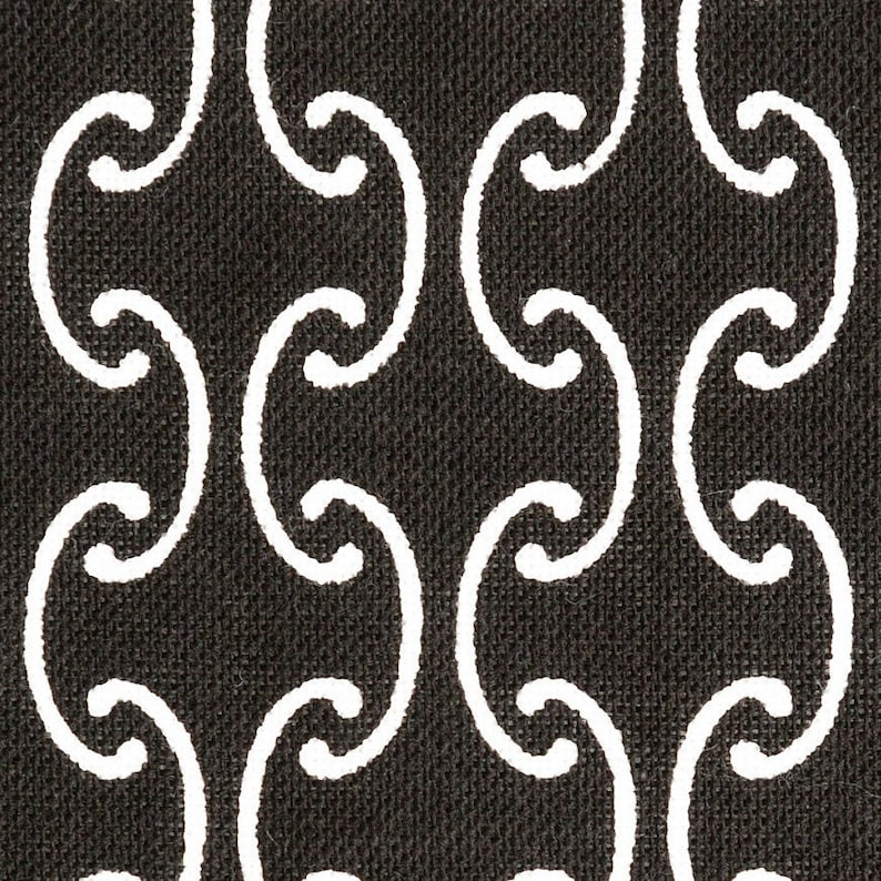 May include: Black and white fabric with a repeating pattern of stylized curved lines. The fabric has a textured surface.