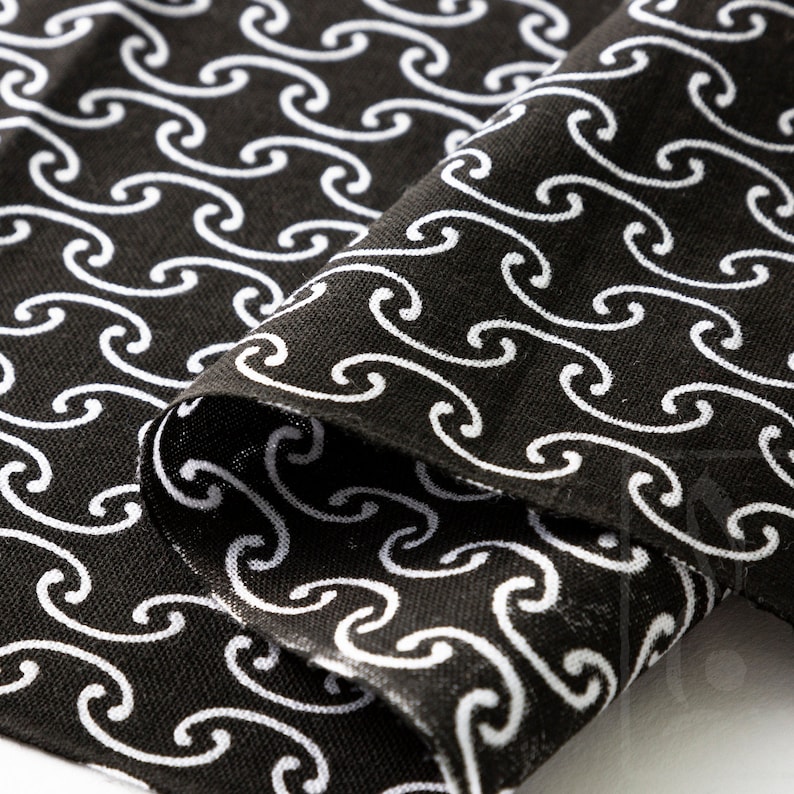 May include: Black fabric with a white repeating pattern of stylized waves.
