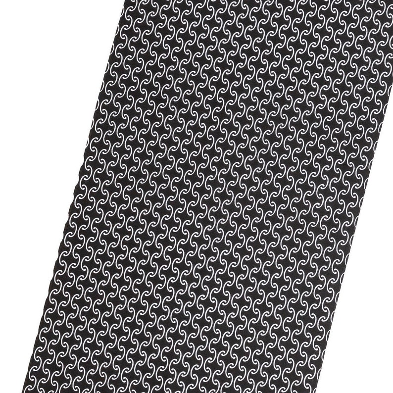 May include: Black tie with a white repeating pattern of curved lines.