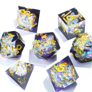 May include: Set of seven polyhedral dice. Each die is a different shape, with gold-colored numbers. The dice are black with iridescent glitter and clear resin. The dice are for tabletop games.