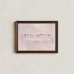 May include: A framed watercolour print showing a group of figures seated around a long table. The artwork uses soft pastel colours, with the figures and table as the focal point. The frame is a dark brown colour.