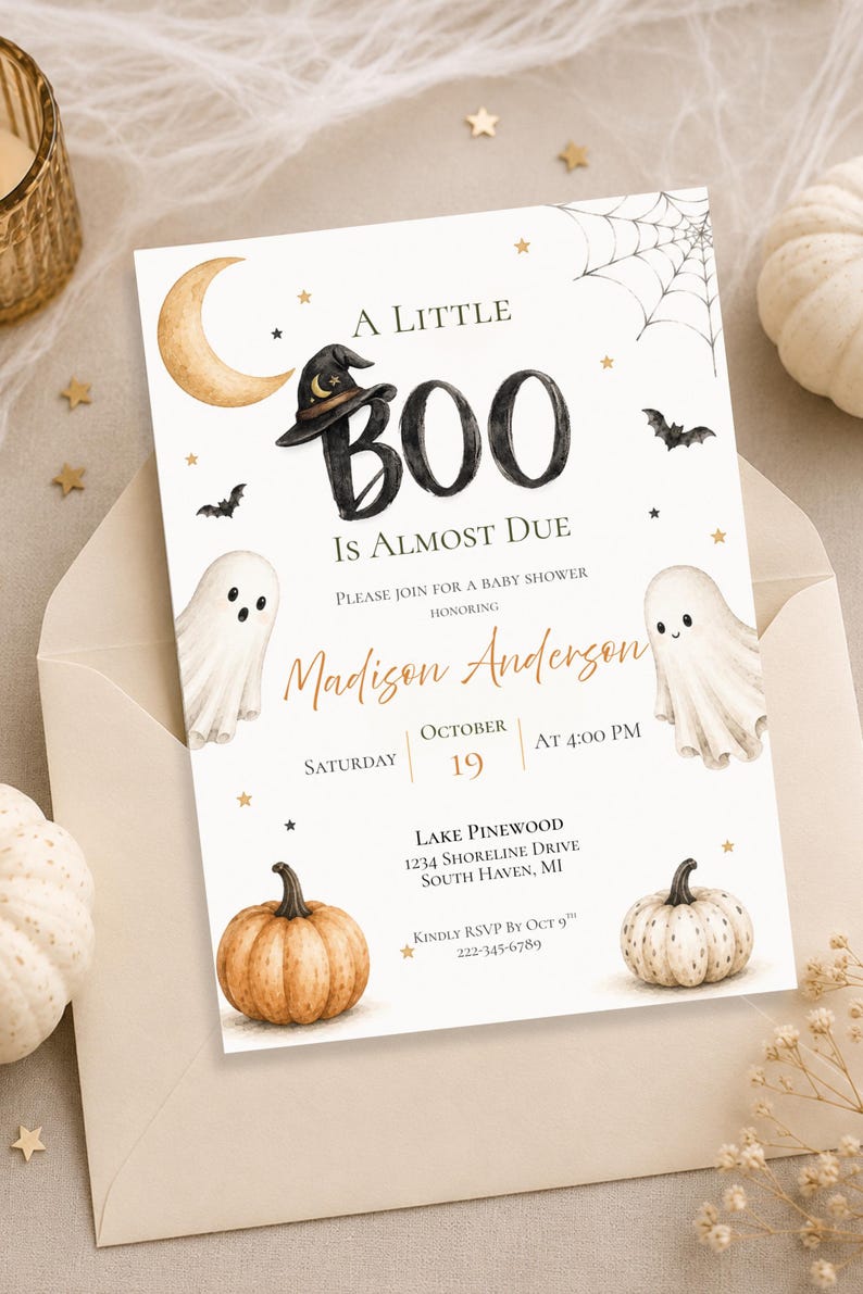 May include: A rectangular baby shower invitation card featuring a watercolor design with a crescent moon, a witch hat, two ghosts, two pumpkins, a spider web, and stars. The text reads A LITTLE BOO IS ALMOST DUE, honoring Madison Anderson, Saturday October 19 at 4:00 PM, Lake Pinewood, 1234 Shoreline Drive, South Haven, MI, and RSVP by Oct 9.