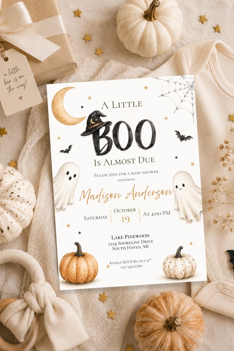 May include: A rectangular baby shower invitation card featuring a watercolor design with a crescent moon, a witch hat, two ghosts, pumpkins, bats, and a spider web. The text reads A LITTLE BOO IS ALMOST DUE, honoring Madison Anderson, Saturday October 19 at 4:00 PM, Lake Pinewood, 1234 Shoreline Drive, South Haven, MI, and RSVP by Oct 9th 222-345-6789.