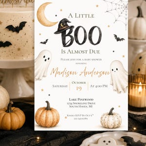May include: A white baby shower invitation card featuring a watercolor illustration of two ghosts, two pumpkins, a crescent moon, and a witch hat. The text reads A LITTLE BOO IS ALMOST DUE, honoring Madison Anderson, Saturday October 19 at 4:00 PM.