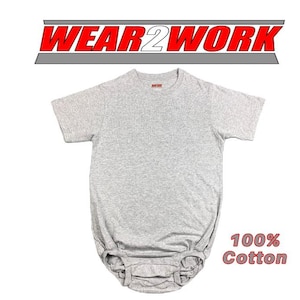 May include: A gray, short-sleeved baby onesie made of 100% cotton. The onesie has a round neckline and a gathered bottom. The text "WEAR2WORK" is displayed above the onesie in red and white. The words "100% Cotton" are displayed in red.
