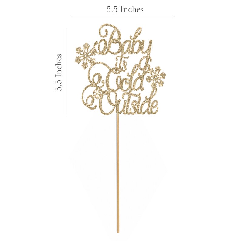 May include: Gold glitter cake topper with the text "Baby It's Cold Outside" and snowflake accents. The topper is 5.5 inches tall.
