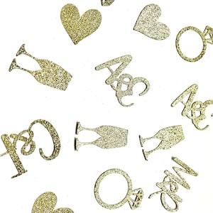 May include: Gold glitter confetti with various shapes including hearts, champagne glasses, rings, and the words "Mr & Mrs" and "Just Married".