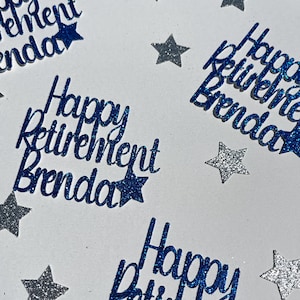 May include: Blue glitter cutouts that read "Happy Retirement Brenda" with star accents. The text is in a cursive font. Scattered around the text are silver glitter star shapes. The background is white.