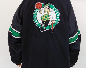 May include: Black Boston Celtics jacket with green and white striped accents on the sleeves. The back features a large team logo with a leprechaun holding a basketball. The jacket has a green and white striped collar and the NBA logo.