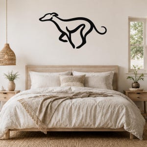 Black metal greyhound silhouette wall art mounted above a wooden bed in a neutral bedroom.