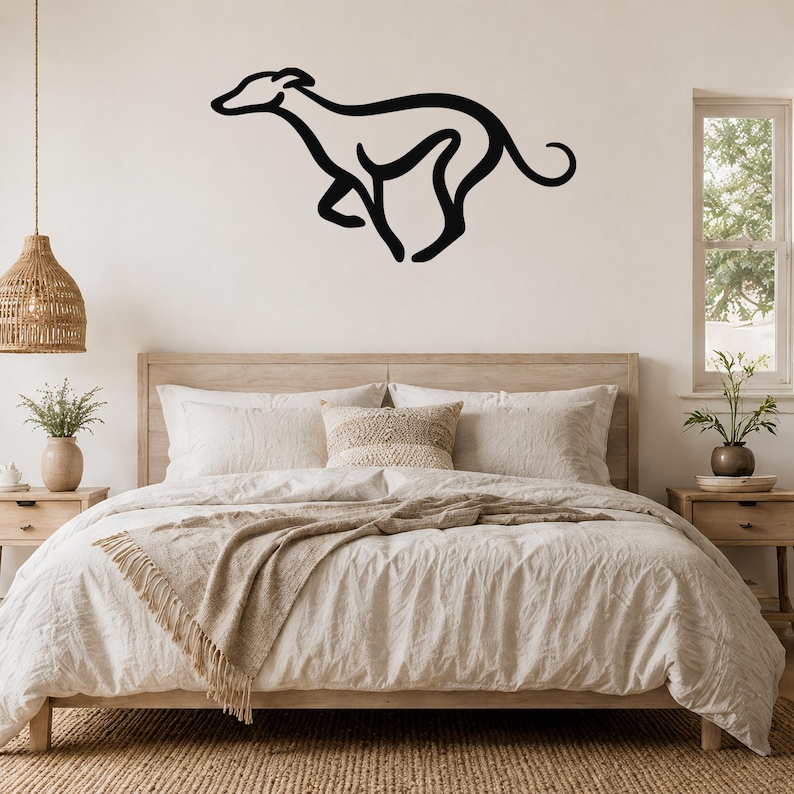 Black metal greyhound silhouette wall art mounted above a wooden bed in a neutral bedroom.