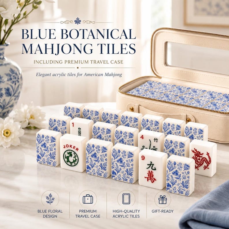 May include: A set of white acrylic Mahjong tiles featuring blue botanical floral patterns, some with red and green character markings including the word JOKER, displayed alongside a beige zippered travel case with a clear window top.