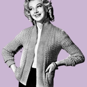 May include: A vintage-style, light gray knitted cardigan with a textured pattern. The open-front sweater features long sleeves, a shawl collar, and two front pockets. The woman in the image is wearing a white shirt and black skirt.