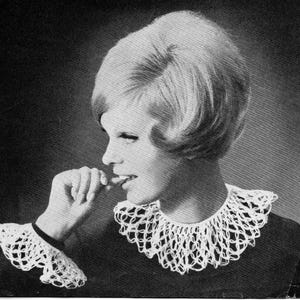 May include: Black and white image of a woman wearing a crocheted collar and cuffs. The collar and cuffs are white and have an open, lacy design. The woman has short, styled hair and is biting her fingernails.