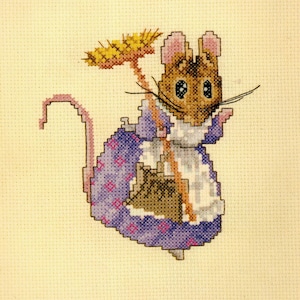 May include: Cross-stitch image of a mouse wearing a purple dress with pink diamond patterns and a white apron. The mouse holds a broom and has a pink tail. The background is a light beige fabric.