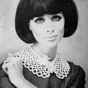 May include: A black and white image of a woman wearing a crocheted white collar with a floral accent. The collar is detailed with an openwork design. The woman has dark hair and is wearing a dark-colored dress.