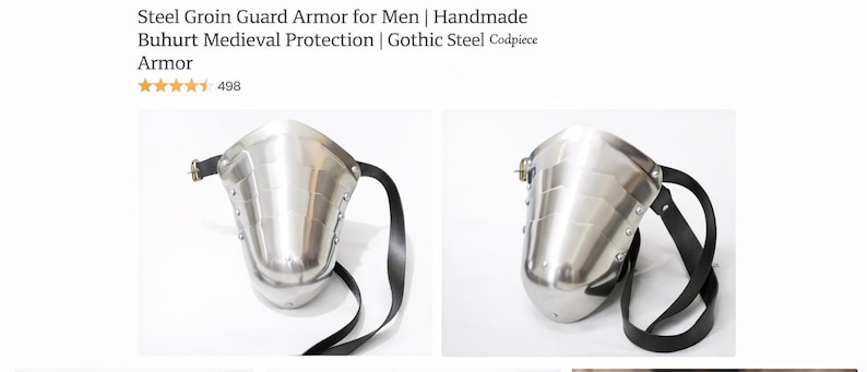 May include: A polished steel groin guard with a curved design, featuring a black leather strap for secure wear. The armor is designed for medieval combat and protection.
