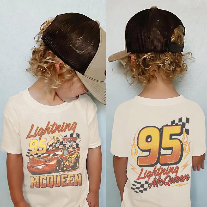 May include: A child wearing a cream-coloured t-shirt and a brown trucker hat. The front of the shirt features a graphic of Lightning McQueen from the film Cars. The back of the shirt displays the number 95 with flames and the words "Lightning McQueen".