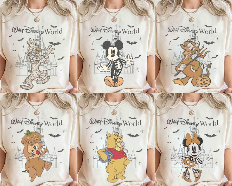 May include: Cream-coloured t-shirts featuring Halloween-themed Disney characters. Designs include a mummy Goofy, skeleton Mickey Mouse, devilish Donald Duck, Chip with a pumpkin, Winnie the Pooh, and Minnie Mouse. Each shirt has the text "Walt Disney World".