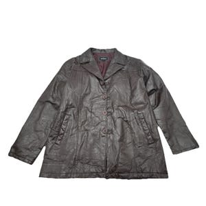 May include: A dark brown leather jacket featuring a collared neckline, long sleeves, and a front button closure with four matching buttons. The jacket includes two vertical side pockets and a dark maroon interior lining visible at the collar.