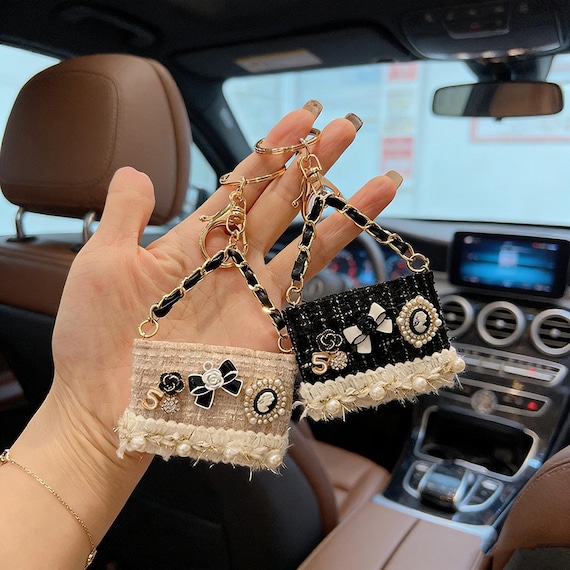 Miniature tweed purse keychain with pearl fringe that looks like a luxury bag charm — tiny fashion statement you actually made yourself.
