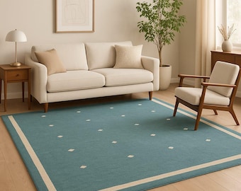 Alfombra de lana tejida a mano, estilo minimalista en color verde azulado con borde color crema.