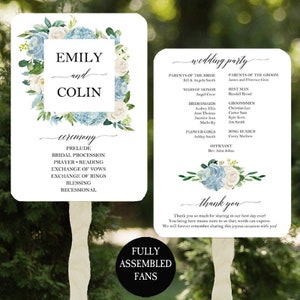 May include: Wedding ceremony program fans with a floral design featuring white and blue flowers. The fans include the names Emily and Colin, the wedding party, and the ceremony order. The text "Fully Assembled Fans" is printed on the bottom of the fans.