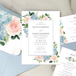 May include: Wedding invitation with floral design in shades of blue and pink. The invitation features the names Olivia Barnes and James Madison, the date Saturday, June 15th, 2020, and the time 2:00 PM. The invitation also includes the location Villa Le Rollo, 123 Woodwine Lane, Newport, CT 12543.