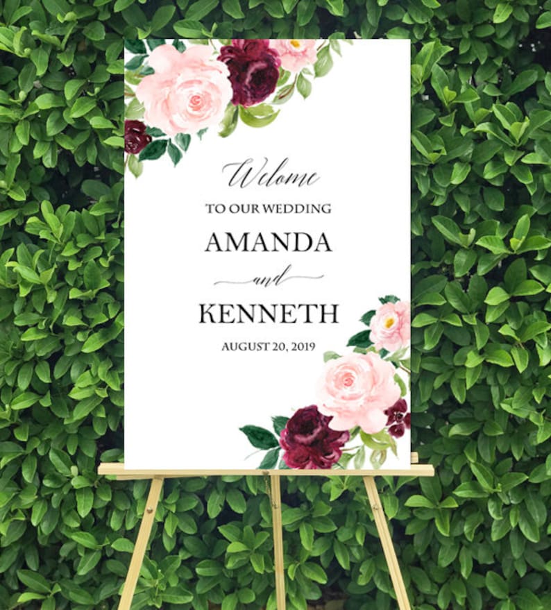 May include: A white wedding welcome sign with burgundy and pink floral illustrations. The sign reads "Welcome to our wedding Amanda and Kenneth August 20, 2019".