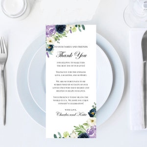 May include: A wedding thank you card with floral accents. The card features the text "Thank You" and a message of gratitude to family and friends. The card is decorated with watercolor flowers in shades of purple, navy, and white.