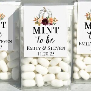 May include: Clear plastic boxes filled with white mints, each labeled with a white square featuring a pumpkin and floral arrangement. The text reads "MINT to be" with names and a date.