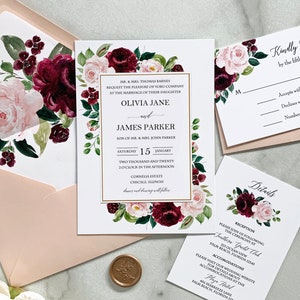 May include: Wedding invitation suite with a floral design featuring burgundy and blush pink flowers. The invitation includes the names Olivia Jane and James Parker, the date and time of the wedding, and the location. The RSVP card includes a space for guests to indicate their attendance. The details card includes information about the reception and accommodations.