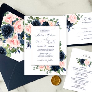 May include: Wedding invitation suite with navy blue and blush pink floral designs. The invitation features the couple's names, wedding date, and location. The RSVP card includes a space for guests to indicate their attendance. The details card provides information about the reception and accommodations.