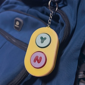 Bluey toy hanging from a backpack.