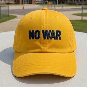 May include: A yellow baseball cap with the embroidered text "NO WAR" in navy blue. The cap has a curved brim and a fabric strap closure. The hat is made of a soft, durable material.
