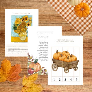 May include: A collection of autumn-themed educational materials on a wooden surface. Includes a print of Van Gogh's sunflowers, a poem titled "Autumn Fires", and a pumpkin puzzle. Decorative pumpkins and fall leaves complete the scene.