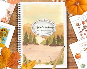 May include: A spiral-bound notebook with an autumn-themed watercolor illustration. The cover features the text "Autumn Morning Menu" within an oval frame. Additional cards with fall-themed illustrations and a pencil are also visible.